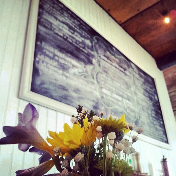 Freshly picked flowers with a hand written chalk board menu - simple but so nice